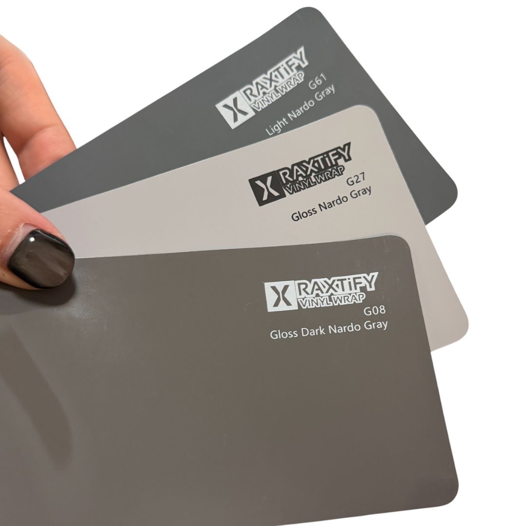 Three Raxtify Vinyl Wrap color sample cards. The cards are labeled G08 Gloss Dark Nardo Gray, G07 Gloss Nardo Gray, and G06 Light Nardo Gray.